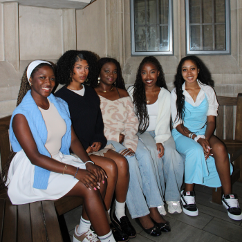 five university students sitting on a bench